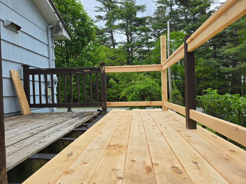 New,Boards,And,Railings,Being,Installed,On,A,Small,Deck