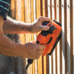 Sanding,Wood.,Close-up,Vibrating,Sander,In,Hands.,Grinding,And,Repairing